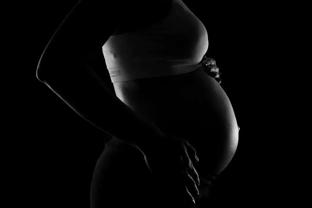 ventre d'une femme enceinte debout de profil
